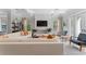 A beautifully decorated living room with coffered ceilings, a white brick fireplace, and ample seating at 4902 Carranza Ct, Tampa, FL 33616