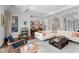 Spacious living room featuring an elegant bar, comfortable seating, and arched doorways leading to other areas at 4902 Carranza Ct, Tampa, FL 33616