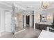 A luxurious bathroom with a glass enclosed shower, tiled floors, and separate vanity areas at 4902 Carranza Ct, Tampa, FL 33616