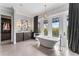Elegant bathroom with a freestanding tub, dual vanity, and balcony access at 4902 Carranza Ct, Tampa, FL 33616