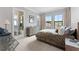 Serene main bedroom featuring neutral tones, large windows, and an ensuite bathroom with a glass shower at 4902 Carranza Ct, Tampa, FL 33616