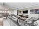 Bright media room includes a large sectional couch, a TV, and stylish light fixtures at 4902 Carranza Ct, Tampa, FL 33616