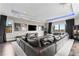 The media room features a large comfortable couch, movie posters, large television, and a projector screen at 4902 Carranza Ct, Tampa, FL 33616