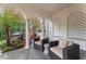 Covered patio with comfortable seating, stylish columns, and views of lush landscaping at 4902 Carranza Ct, Tampa, FL 33616