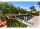 Inviting backyard pool area with lush landscaping, a seating area, and a tranquil atmosphere at 4902 Carranza Ct, Tampa, FL 33616