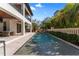 Inviting pool area with stone patio, lush landscaping, and fountains, creating a private backyard oasis at 4902 Carranza Ct, Tampa, FL 33616