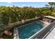 Aerial view of the backyard with a sparkling pool, elegant patio furniture, and well-manicured landscaping at 4902 Carranza Ct, Tampa, FL 33616