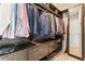 Large walk-in closet featuring custom shelving, hanging rods, drawers, and a full length mirror at 4902 Carranza Ct, Tampa, FL 33616