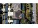 Aerial view of a home with a screened-in pool, a well-manicured lawn, and nearby street access at 5709 Camila Song Ln, Tampa, FL 33625