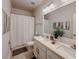 Bright bathroom features a double vanity, shower with curtain, and stylish decor for relaxation at 5709 Camila Song Ln, Tampa, FL 33625