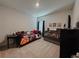 bedroom with sports decor, a daybed with colorful pillows, and a crib for a cozy space at 5709 Camila Song Ln, Tampa, FL 33625