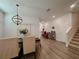 Spacious dining room featuring wood floors, modern chandelier, and room to entertain at 5709 Camila Song Ln, Tampa, FL 33625