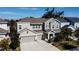 Beautiful exterior view of a two-story home with a three-car garage, well-kept lawn, and charming entryway at 5709 Camila Song Ln, Tampa, FL 33625
