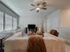 Bright living room with comfortable seating, a ceiling fan, and a neutral color palette at 5709 Camila Song Ln, Tampa, FL 33625