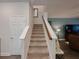 Carpeted staircase leading to the upper level, offering a seamless transition between floors at 5709 Camila Song Ln, Tampa, FL 33625