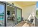 Balcony with bay view, seating and access to living area at 7520 Sunshine Skyway S Ln # T18, St Petersburg, FL 33711