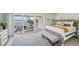Bright bedroom with a balcony showcasing ocean views, alongside modern decor at 7520 Sunshine Skyway S Ln # T18, St Petersburg, FL 33711