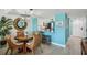 Dining room with wood table, seating for four, and kitchen view at 7520 Sunshine Skyway S Ln # T18, St Petersburg, FL 33711