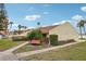 Inviting condo exterior with lush landscaping, seating, and beach access at 7520 Sunshine Skyway S Ln # T18, St Petersburg, FL 33711