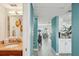 Hallway showcasing the bathroom, living room, and kitchen with stylish blue accent walls at 7520 Sunshine Skyway S Ln # T18, St Petersburg, FL 33711
