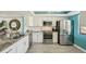 Bright kitchen featuring white cabinetry, granite countertops, and stainless steel appliances at 7520 Sunshine Skyway S Ln # T18, St Petersburg, FL 33711
