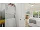 Efficient laundry area with a stacked washer and dryer next to the bedroom at 7520 Sunshine Skyway S Ln # T18, St Petersburg, FL 33711