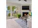Cozy living room with fireplace, television, and a sliding door to a beautiful waterfront view at 7520 Sunshine Skyway S Ln # T18, St Petersburg, FL 33711