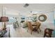 Open concept living and dining area with balcony and water view at 7520 Sunshine Skyway S Ln # T18, St Petersburg, FL 33711