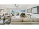 Bright living room with fireplace, white sofas, and water view from the balcony at 7520 Sunshine Skyway S Ln # T18, St Petersburg, FL 33711