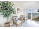 Bright living room featuring wicker seating and stunning water views at 7520 Sunshine Skyway S Ln # T18, St Petersburg, FL 33711