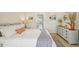 Bright main bedroom with soft lighting and pastel blue painted dresser for ample storage at 7520 Sunshine Skyway S Ln # T18, St Petersburg, FL 33711