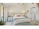 Bright main bedroom with sliding glass door access to the balcony and pastel blue nightstands at 7520 Sunshine Skyway S Ln # T18, St Petersburg, FL 33711
