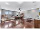 Large bonus room with wood floors, a ceiling fan, shelving, and multiple windows at 10409 Waterstone Dr, Riverview, FL 33578