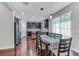 Open concept dining area with wood floors, pendant lighting, and sliding glass doors to the exterior at 10409 Waterstone Dr, Riverview, FL 33578