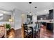 Dining area leading to the kitchen with wood floors, pendant lighting, and gray walls at 10409 Waterstone Dr, Riverview, FL 33578