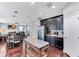 Open kitchen with stainless steel refrigerator, wood floors, island, and dark cabinetry at 10409 Waterstone Dr, Riverview, FL 33578