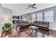 Comfortable living room boasts hardwood floors, modern decor, and views into the kitchen at 10409 Waterstone Dr, Riverview, FL 33578