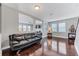 Comfortable living room features hardwood floors, natural light, and modern decor at 10409 Waterstone Dr, Riverview, FL 33578