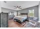 Comfortable main bedroom featuring hardwood floors, a ceiling fan, and sitting area at 10409 Waterstone Dr, Riverview, FL 33578