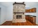 Living room featuring stone fireplace, wet bar and hardwood floors at 118 Laurel Tree Way, Brandon, FL 33511
