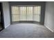Bright living room featuring a bay window and neutral gray carpet flooring at 118 Laurel Tree Way, Brandon, FL 33511