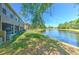 Backyard featuring lush green lawn, fountain pond, and screened patio at 18827 Duquesne Dr, Tampa, FL 33647