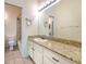 Bathroom features a granite countertop vanity, tile floors, and a shower/tub combo at 18827 Duquesne Dr, Tampa, FL 33647