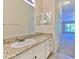 Bathroom features a granite countertop vanity, tile floors, and a large mirror at 18827 Duquesne Dr, Tampa, FL 33647