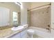 Bathroom featuring a granite countertop vanity and a shower/tub combo at 18827 Duquesne Dr, Tampa, FL 33647