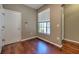 Neutral bedroom with hardwood floors and a window with blinds at 18827 Duquesne Dr, Tampa, FL 33647