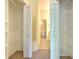 Walk in closet with dual closets and a hallway leading to a bathroom at 18827 Duquesne Dr, Tampa, FL 33647