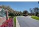 Welcoming entrance to The Promenade with beautiful landscaping and well-maintained grounds in a desirable community at 18827 Duquesne Dr, Tampa, FL 33647