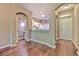 Inviting interior view showcasing hardwood floors, a bathroom, and a glimpse of the kitchen at 18827 Duquesne Dr, Tampa, FL 33647