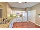 Bright kitchen with white cabinets, granite countertops, and stainless-steel appliances at 18827 Duquesne Dr, Tampa, FL 33647